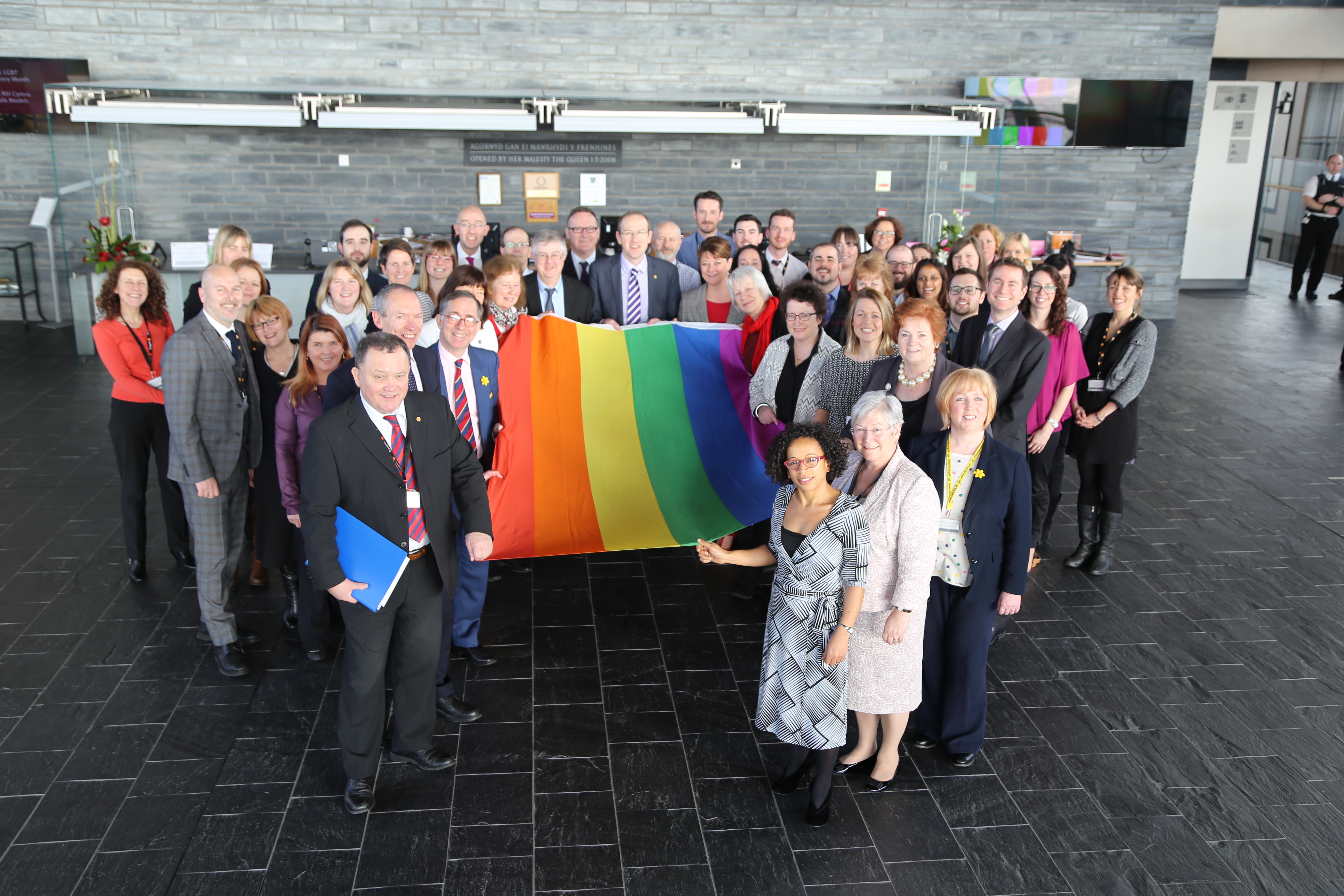 Photograph of Assembly LGBT staff and Allies holding the rainbow flag for LGBT History Month